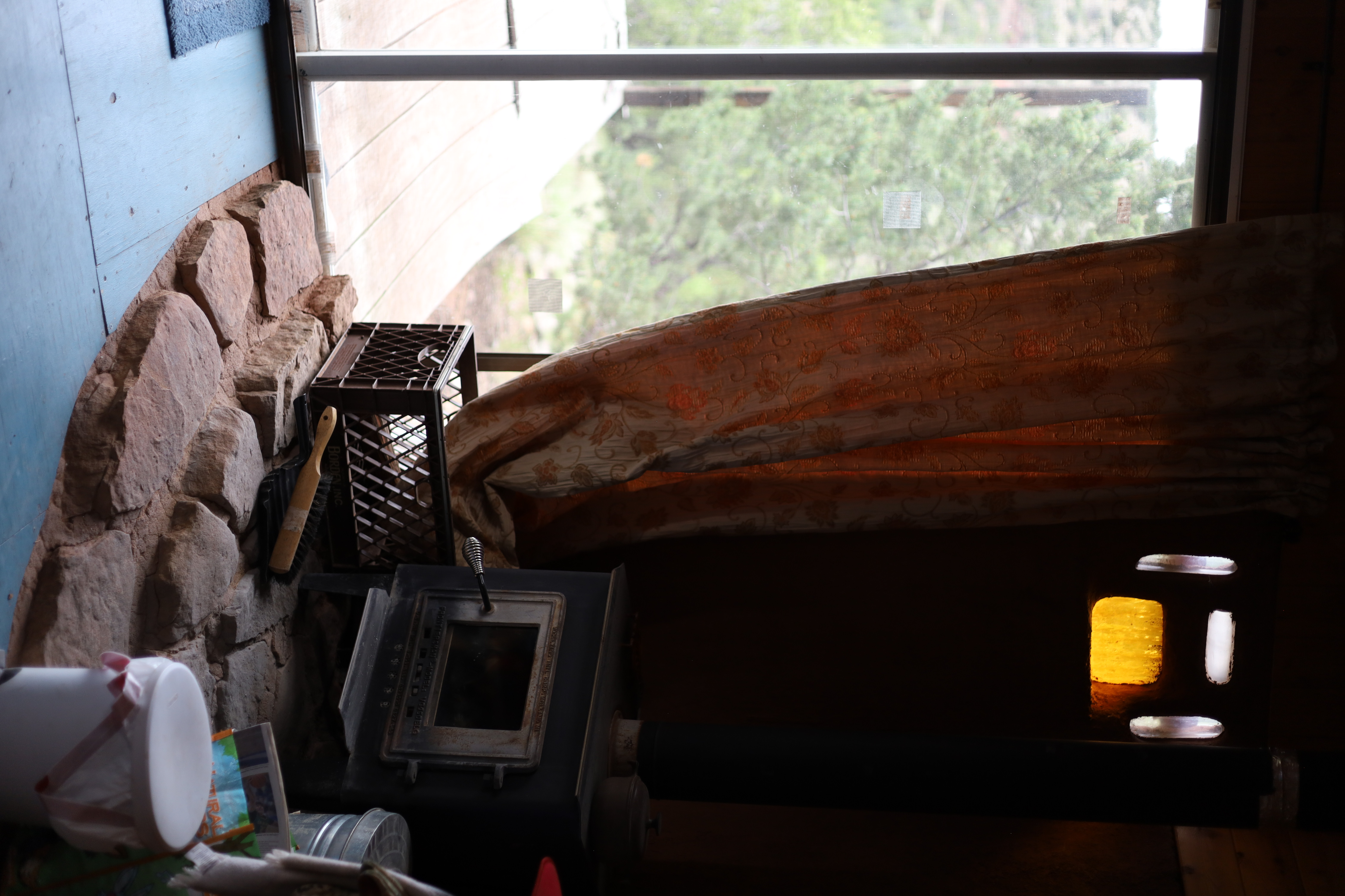 A rustic wood stove inside a casita